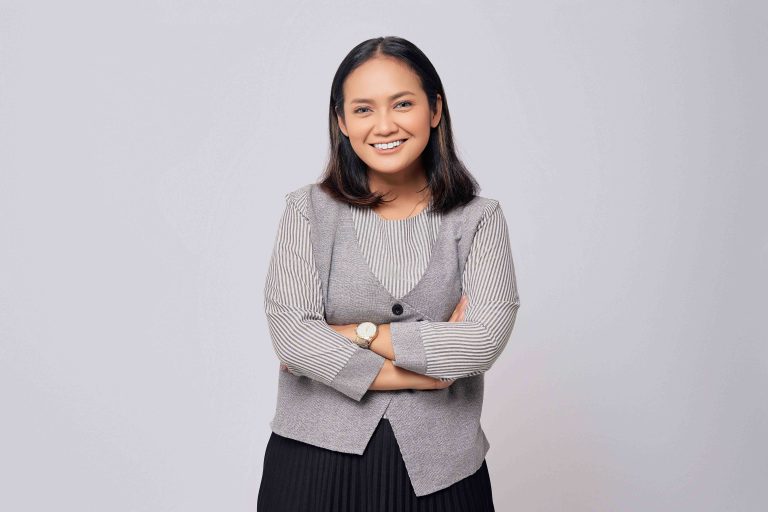 Satisfied smiling happy successful young Asian employee business